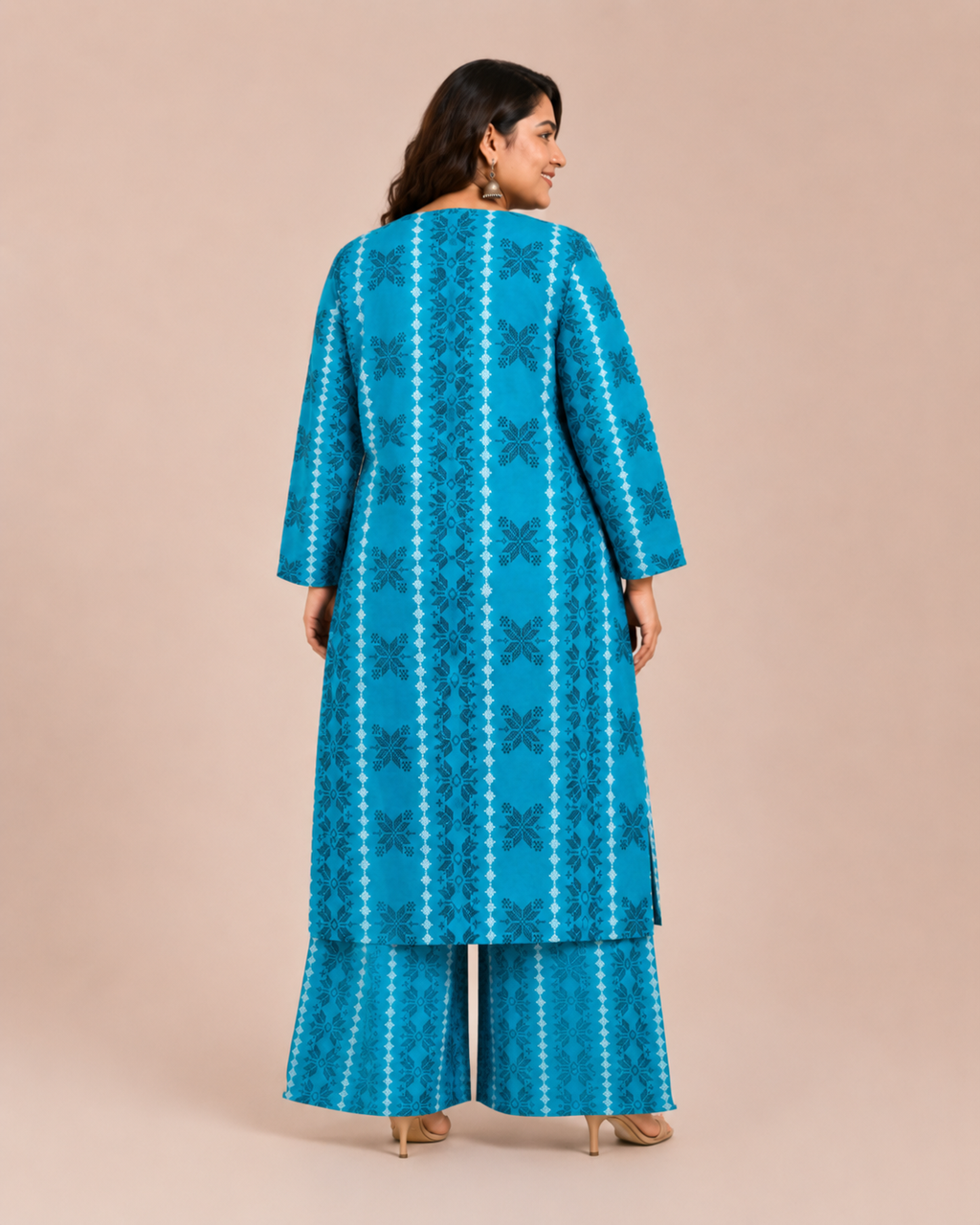 Back view of a smiling plus-size model posing in a matching teal blue vertical geometric stripe printed cotton lawn kurta and wide trouser co-ord set.