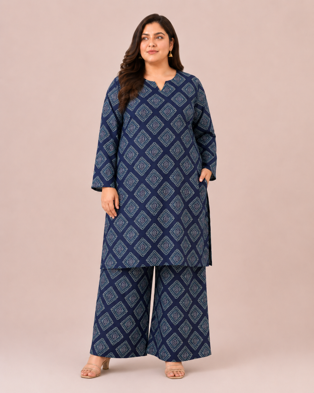 Front three-quarter view of a plus-size model posing in a matching navy blue and cream geometric grid block printed cotton lawn kurta and wide trouser co-ord set.
