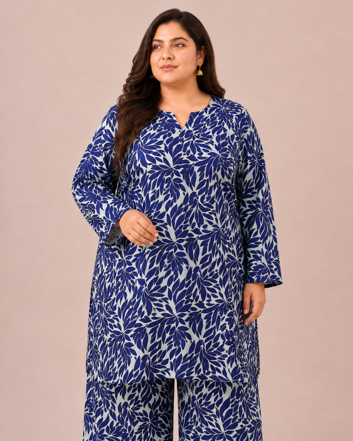 Front view of a plus-size model posing in a matching indigo blue and steel gray abstract leaf printed cotton lawn kurta and wide trouser co-ord set.
