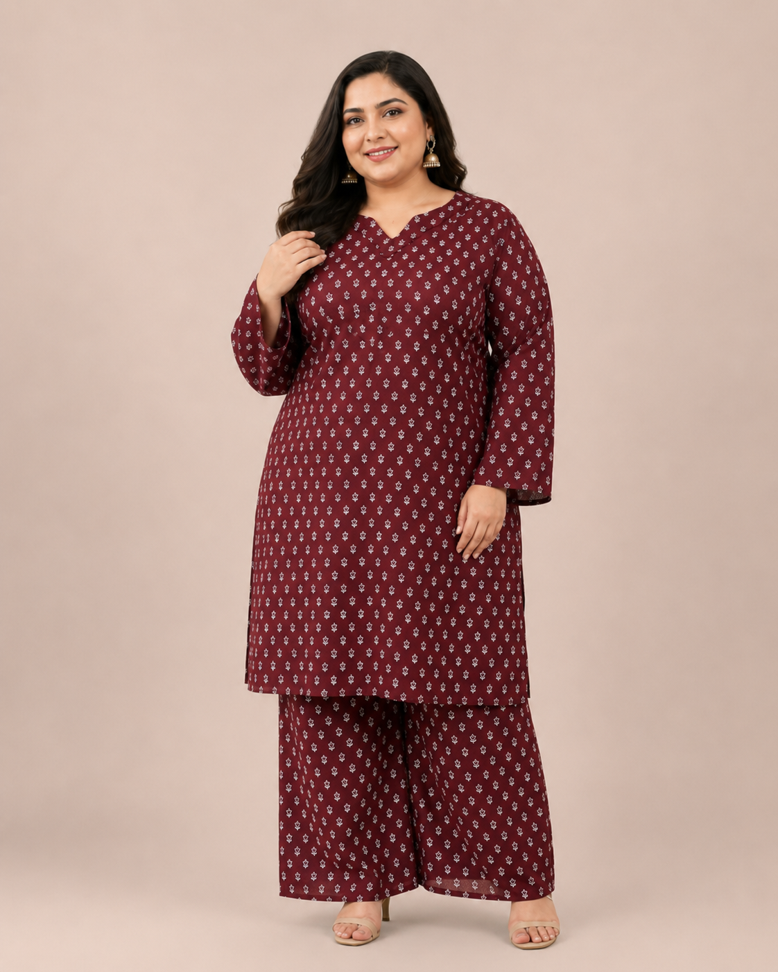 Front view of a smiling plus-size model posing in a matching deep maroon and white miniature floral printed cotton lawn kurta and wide trouser co-ord set.