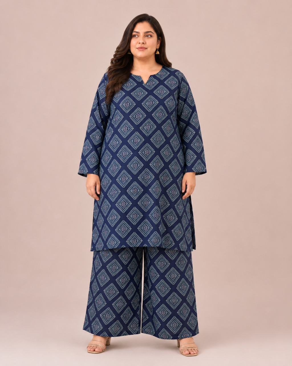 Front three-quarter view of a plus-size model posing in a matching navy blue and cream geometric grid block printed cotton lawn kurta and wide trouser co-ord set.