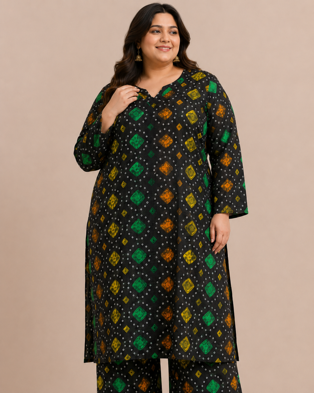 Front view of a plus-size model posing in a matching black, green, and orange multicolored chunri bandhani printed cotton lawn kurta and wide trouser co-ord set.