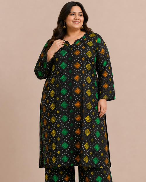 Front view of a plus-size model posing in a matching black, green, and orange multicolored chunri bandhani printed cotton lawn kurta and wide trouser co-ord set.