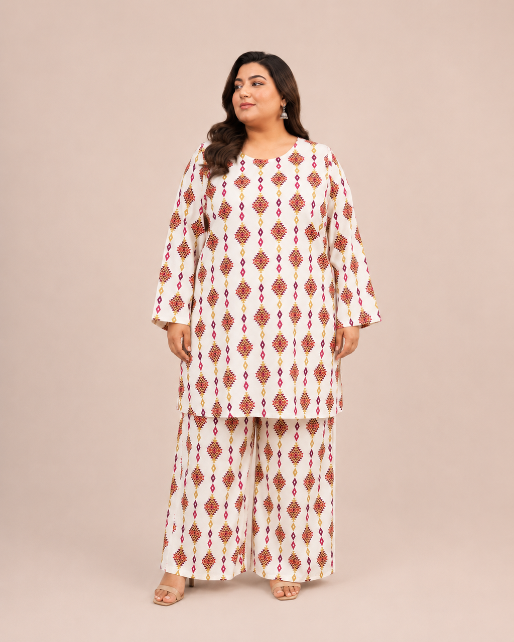 Front view of a plus-size model posing in a matching off-white and red geometric diamond printed cotton lawn kurta and wide trouser co-ord set.