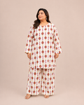 Front view of a plus-size model posing in a matching off-white and red geometric diamond printed cotton lawn kurta and wide trouser co-ord set.