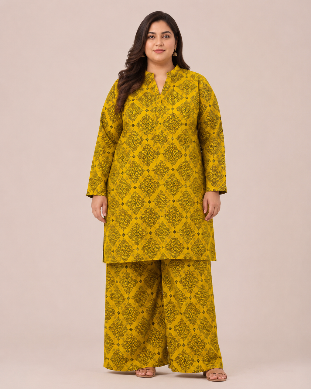 Front view of a smiling plus-size model posing in a matching mustard yellow and black geometric checkered printed cotton lawn kurta and wide trouser co-ord set.