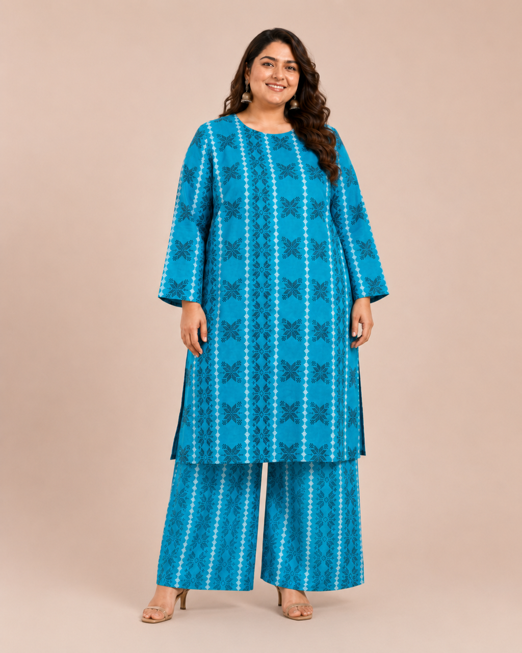 Front view of a smiling plus-size model posing in a matching teal blue vertical geometric stripe printed cotton lawn kurta and wide trouser co-ord set.