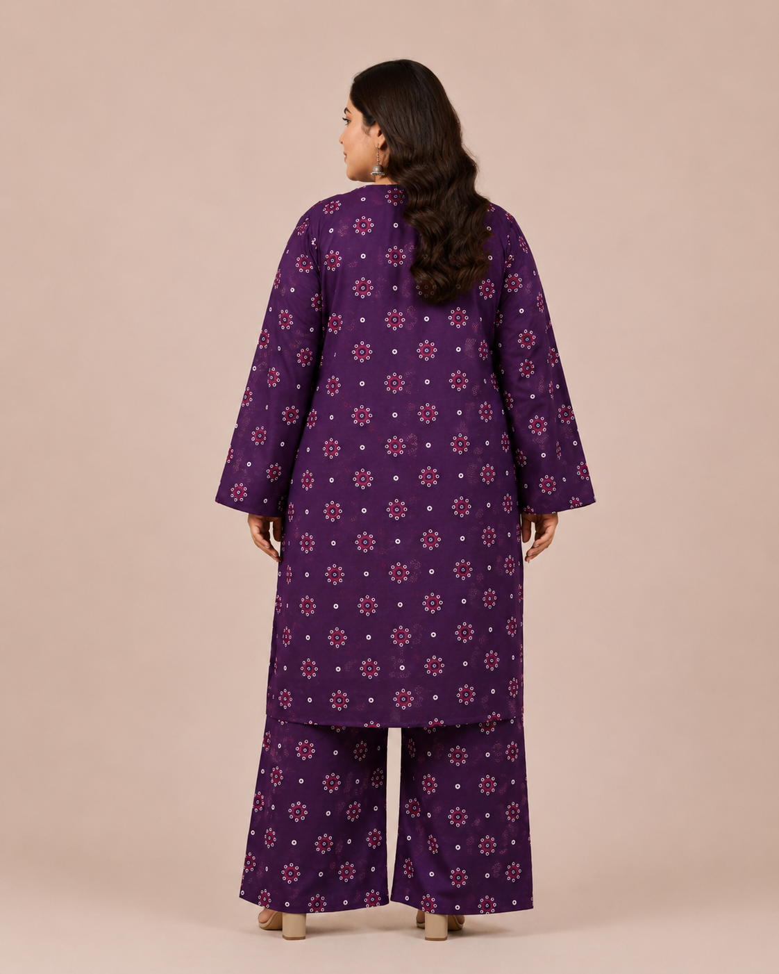 Front view of a smiling plus-size model posing in a matching deep violet 3-piece chunri printed cotton lawn kurta set with a dupatta.